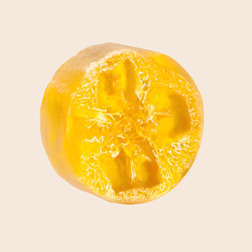 Yellow soap with a textured surface on a white background