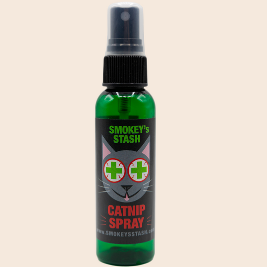 Green spray bottle labeled 'Smokey's Stash Catnip Spray' on a white background