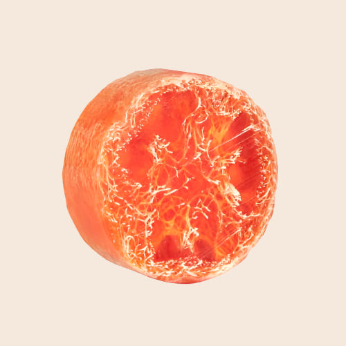 Orange soap with a unique texture on a white background