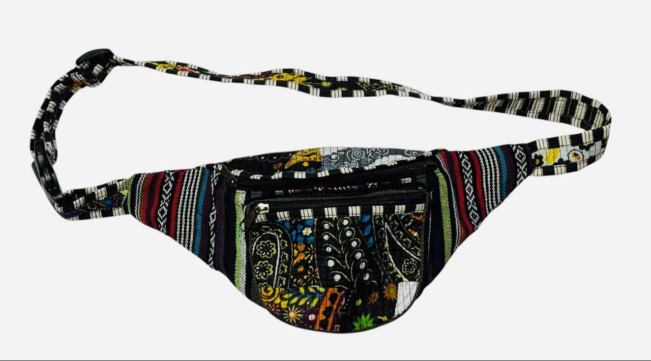 A multicolor patterned fanny pack with a black and white striped adjustable strap, shown against a plain light gray background.