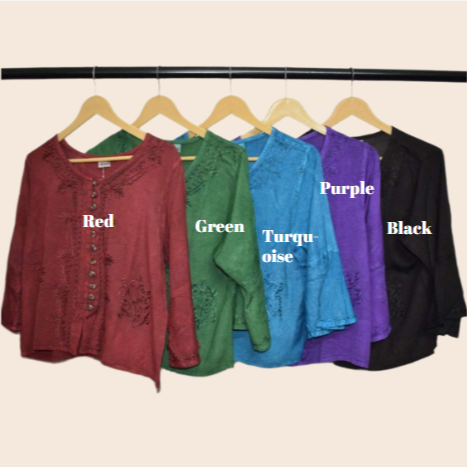 Five shirts in red, green, turquoise, purple, and black on hangers with color labels.