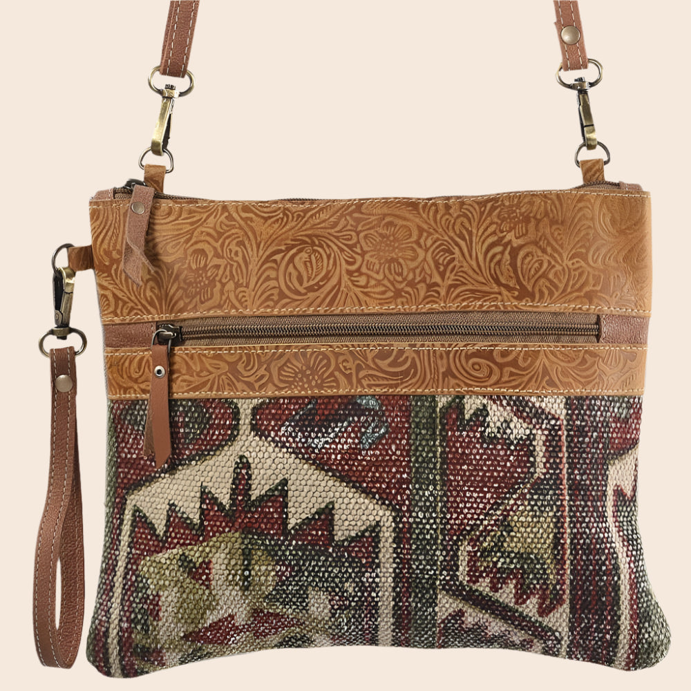 Multicolored patterned crossbody bag with brown strap and zipper
