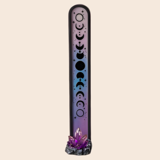 Decorative incense stick holder with moon phases design on a white background