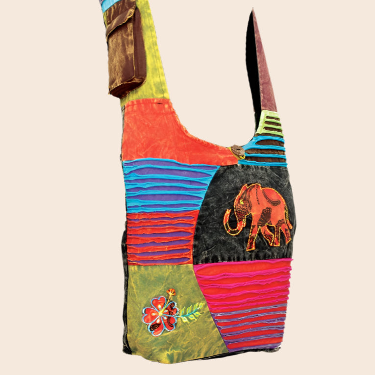 Colorful patchwork bag with elephant design on a white background