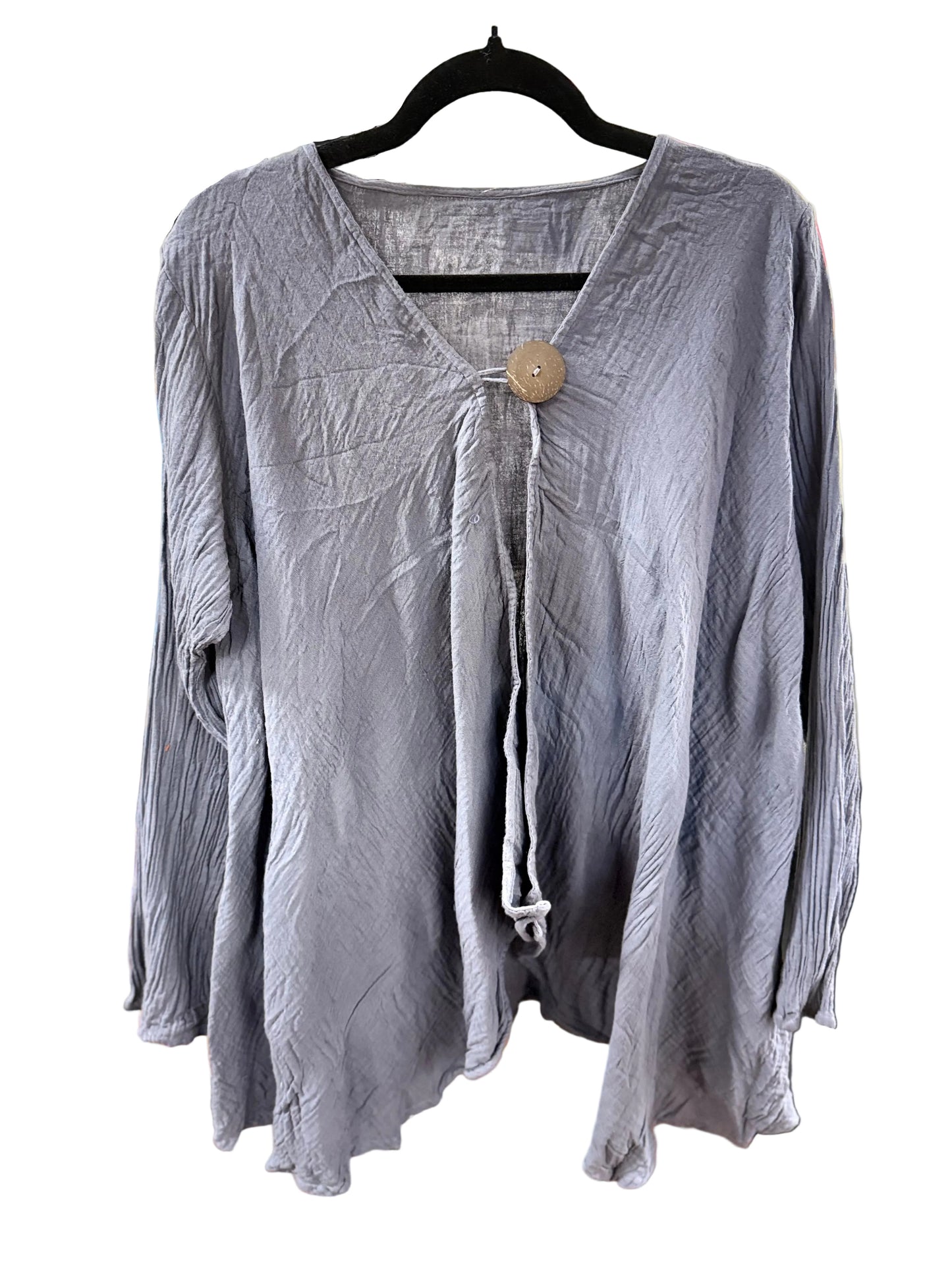 A crinkled, long-sleeve lavender-gray blouse hanging on a black hanger on a white background. It features a split V-neckline with a central tie and a single large wooden button.