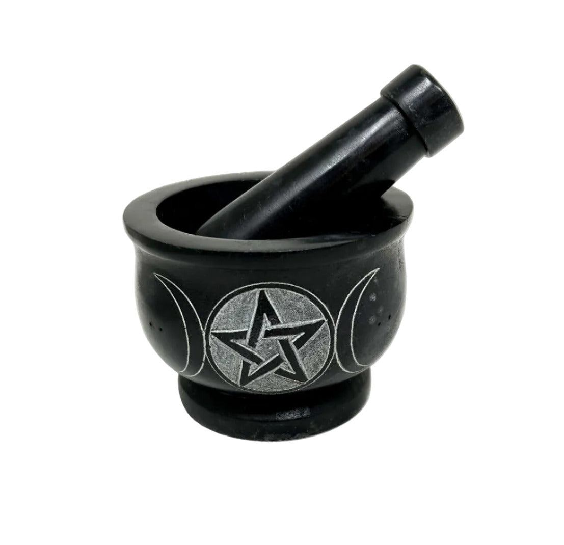 Black mortar and pestle with star design on a white background