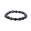 A stretchable bracelet made with black and blue acrylic beads designed to resemble evil eyes, set against a white background.