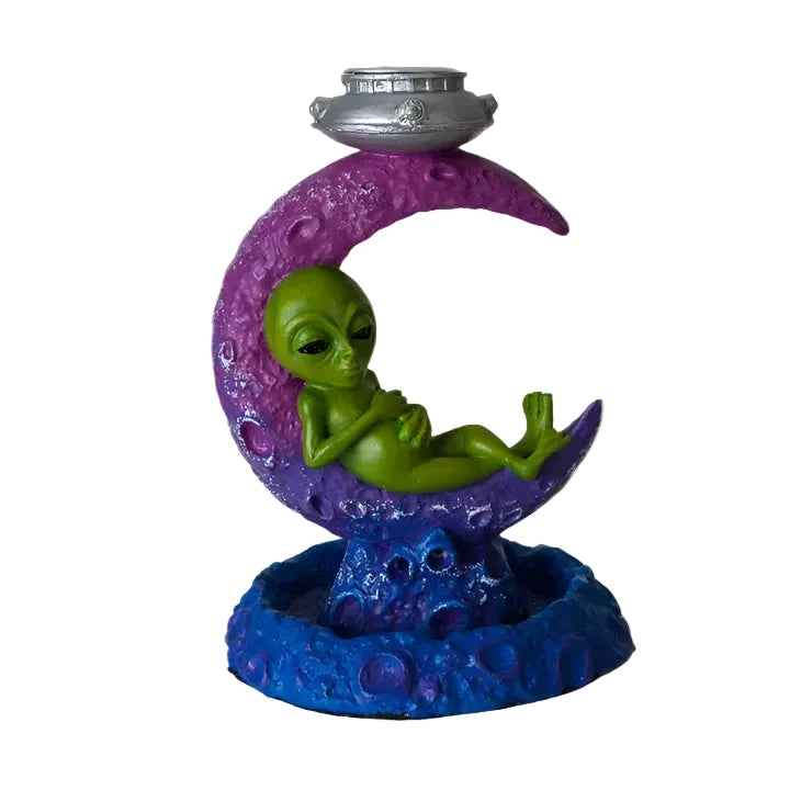 Decorative figurine of an alien on a purple crescent moon with a blue base.