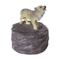 Small trinket box featuring a statue of a wolf on a rocky base with a white background