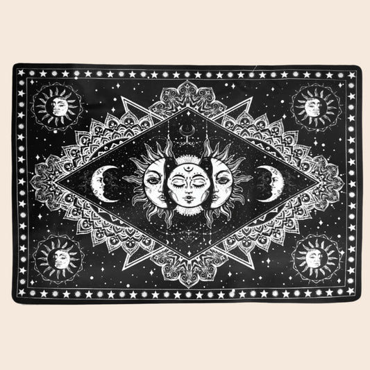 Decorative mat with celestial design featuring suns, moons, and stars on a black background.