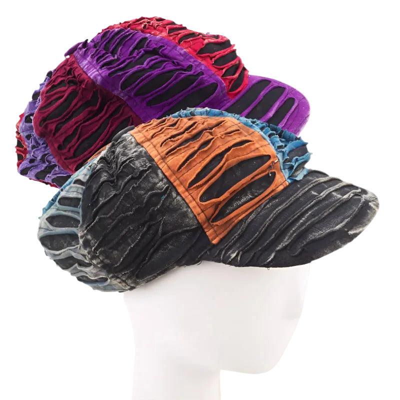 A collection of news boy caps with a unique razor cut design, displayed in black, red, purple, and orange colors.