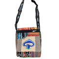 A colorful patchwork embroidered bag featuring a mushroom design, with an adjustable strap and multiple pockets.
