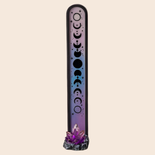 Decorative incense stick holder with moon phases design on a white background