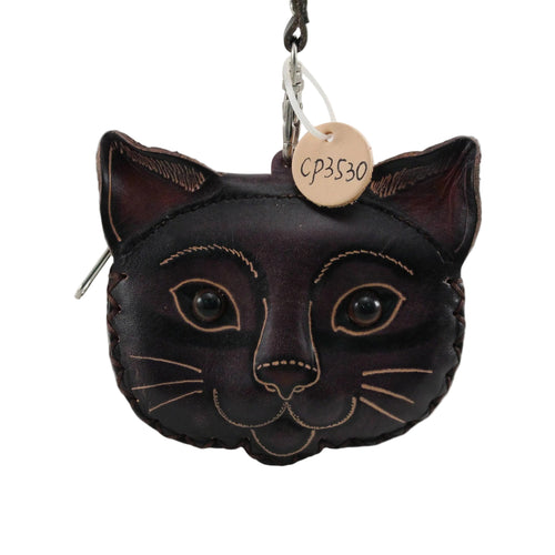 Black cat-shaped coin purse with a tag on a beige background
