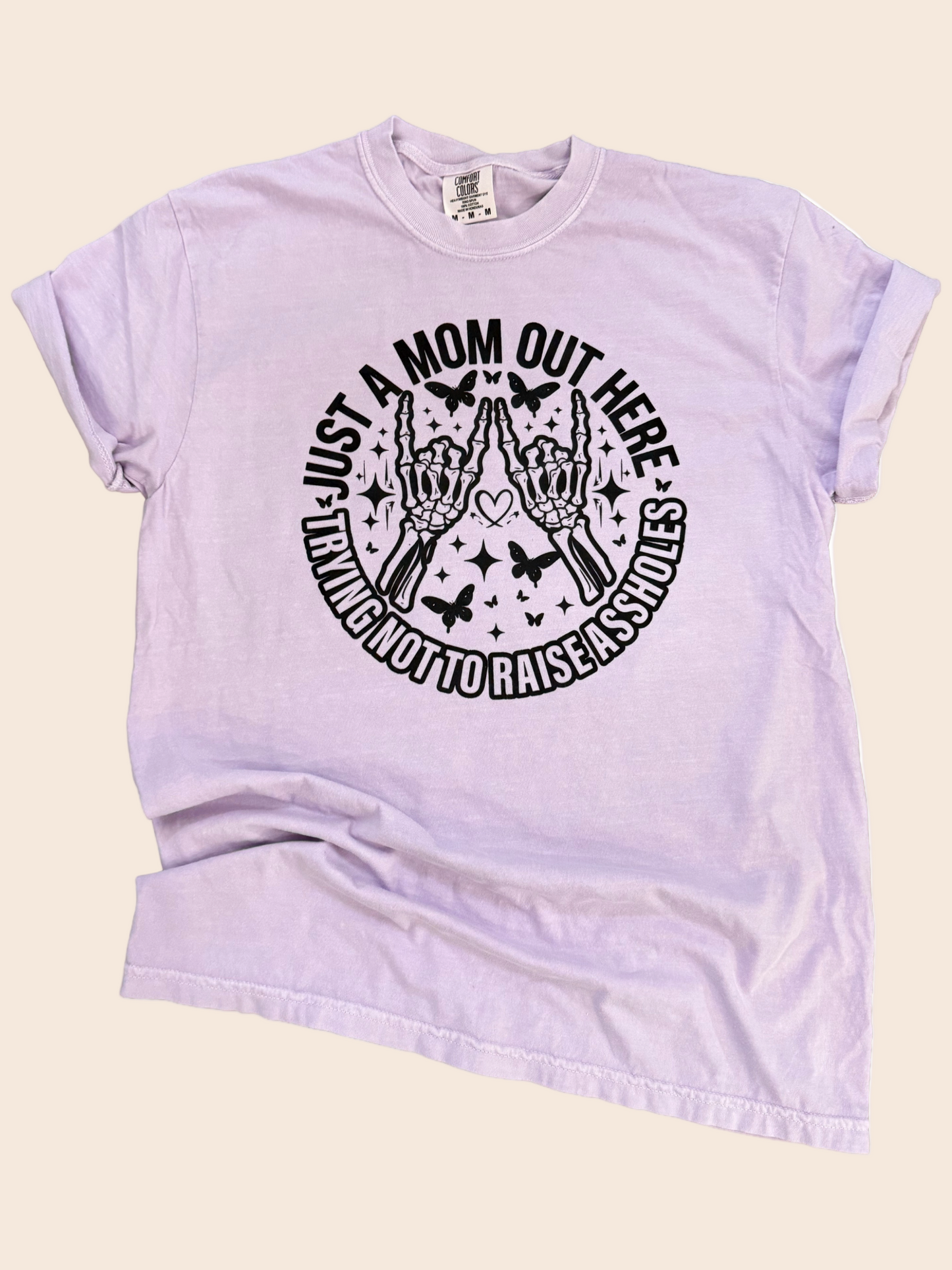 Just a Mom Out Here Trying Not To Raise A**holes- Mom Life Tee
