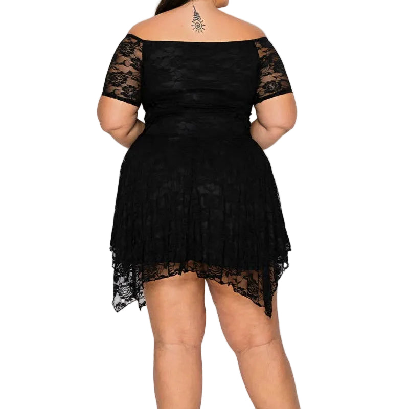A woman viewed from the back wearing a black off-the-shoulder lace mini dress with sheer short sleeves and a flared skirt, paired with black high heels against a plain light gray studio background.