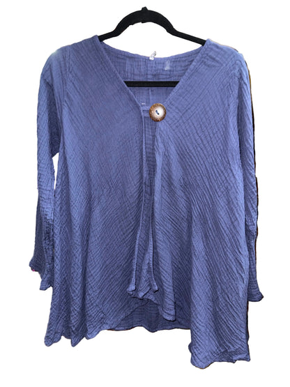A textured lavender-purple long-sleeve blouse with a V-neckline, front tie detail, and a decorative wooden button, hanging on a black hanger on a white background.