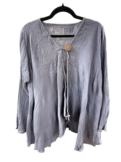 A crinkled, long-sleeve lavender-gray blouse hanging on a black hanger on a white background. It features a split V-neckline with a central tie and a single large wooden button.