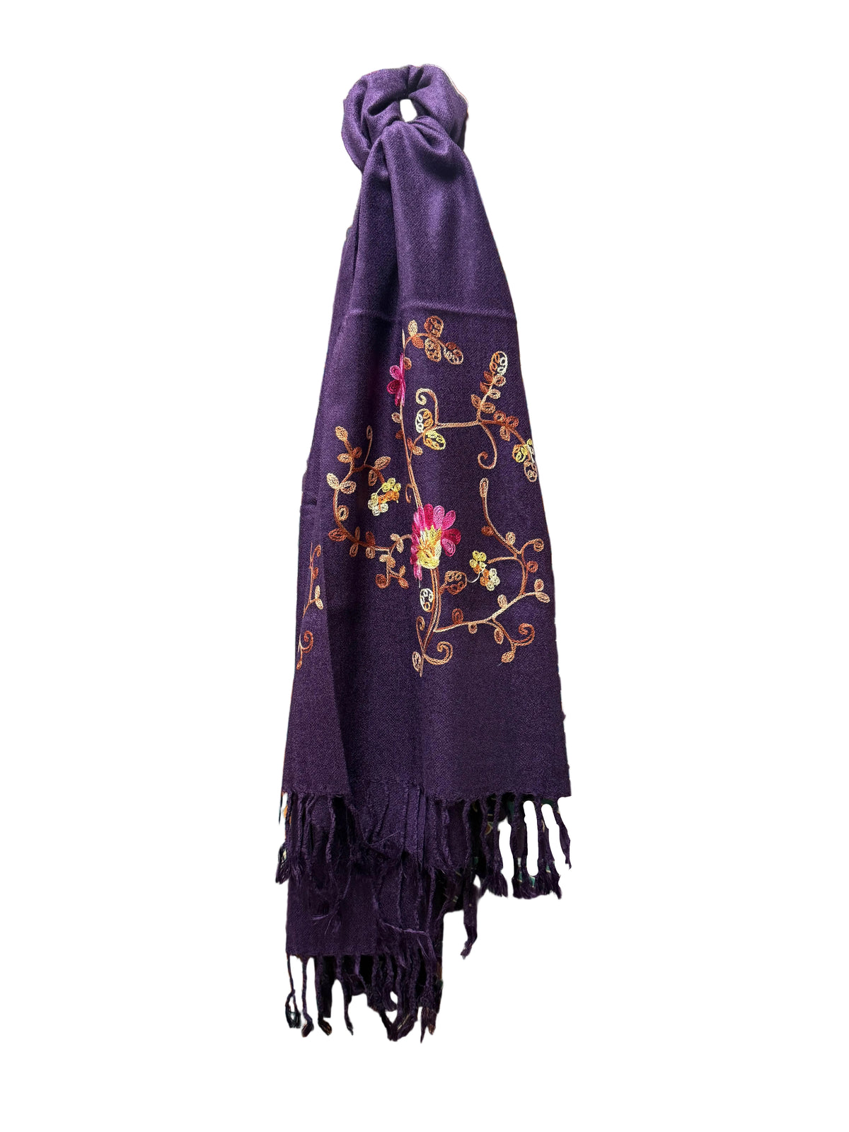 A deep purple woven scarf with colorful floral embroidery and fringe on a white background.